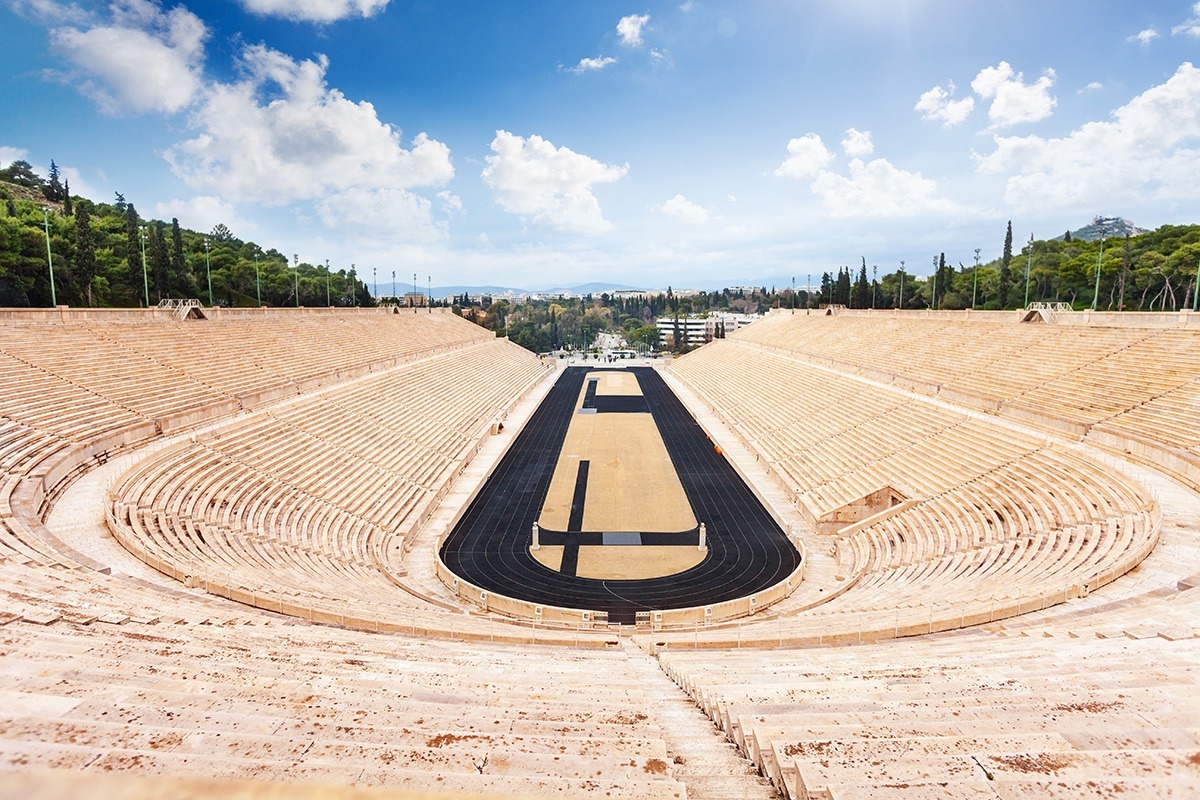 Symmetric view of Panathenaic Stadium in Athens, Greece in summer with stairs and city on background