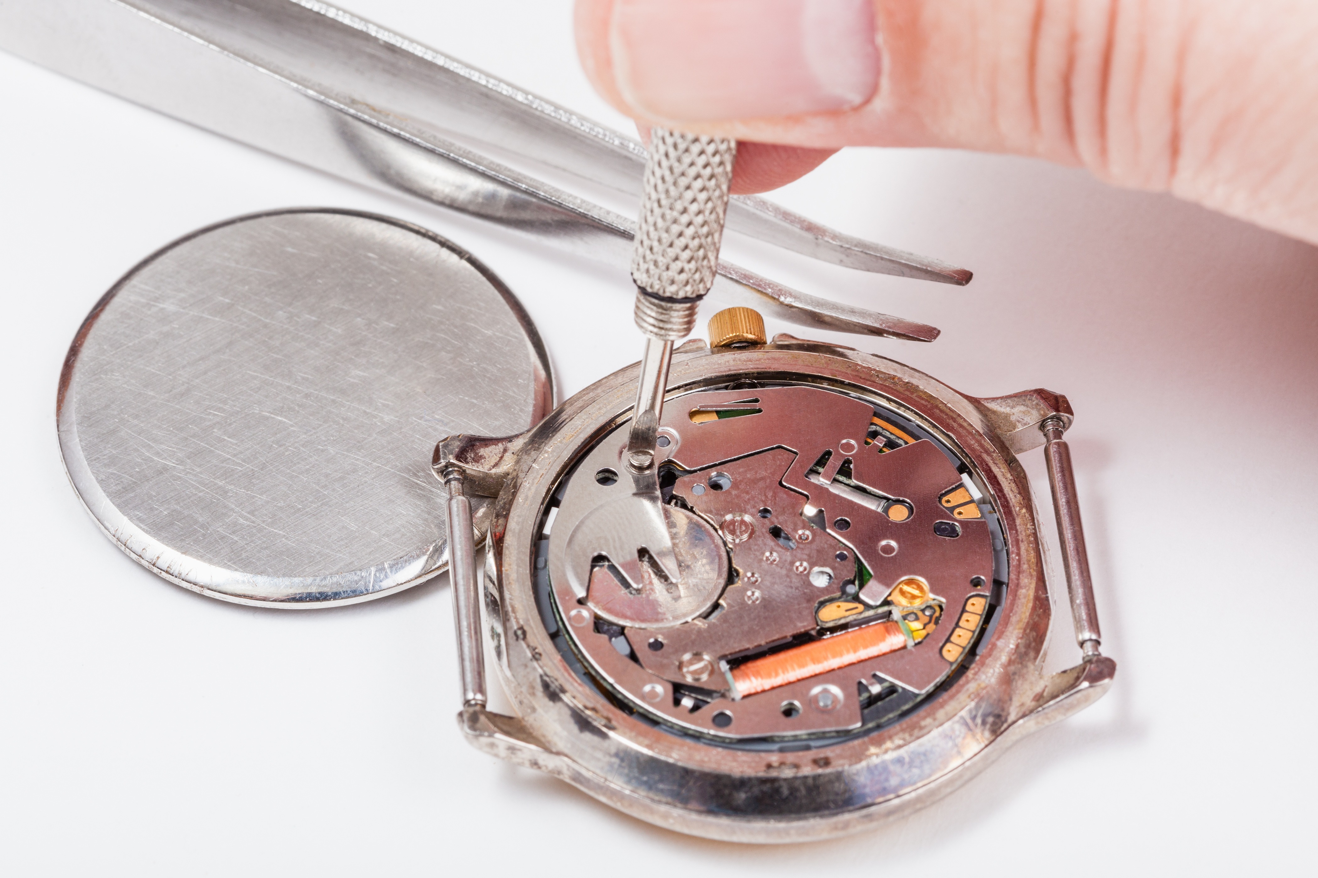 Repairing of watch - watchmaker replaces battery in quartz wristwatch close up