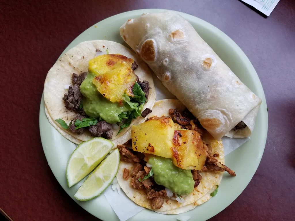 Tacos and a burrito on a plate