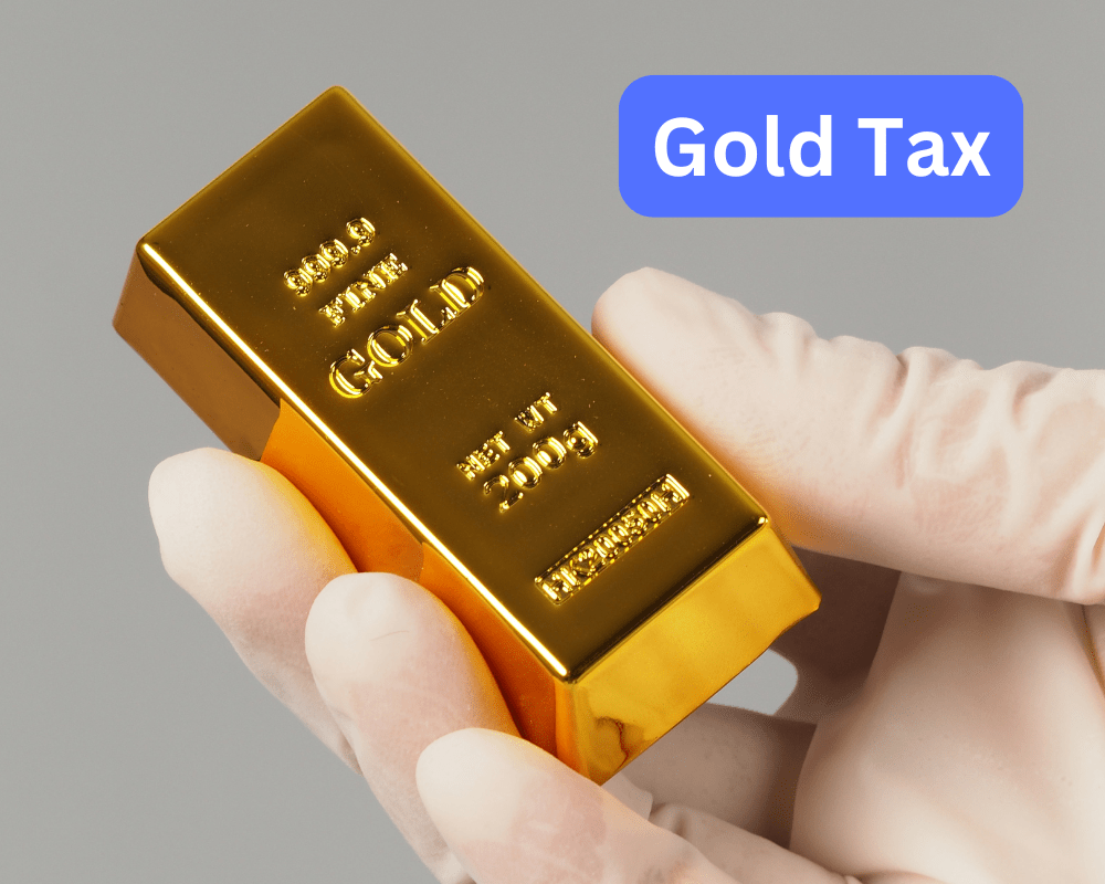 gloved hand holding a gold bar